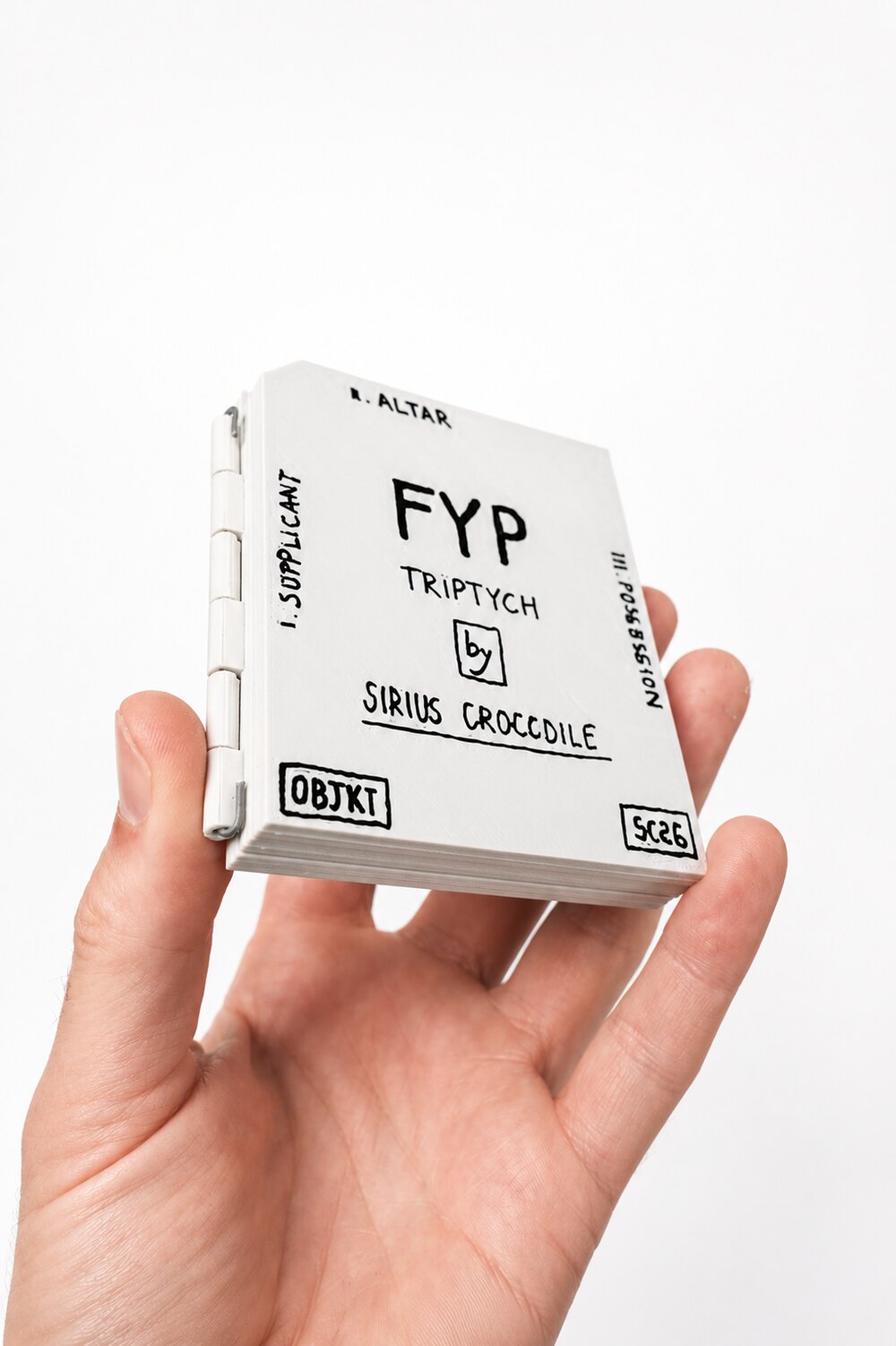 The closed FYP triptych held in a hand, showing its palm scale.